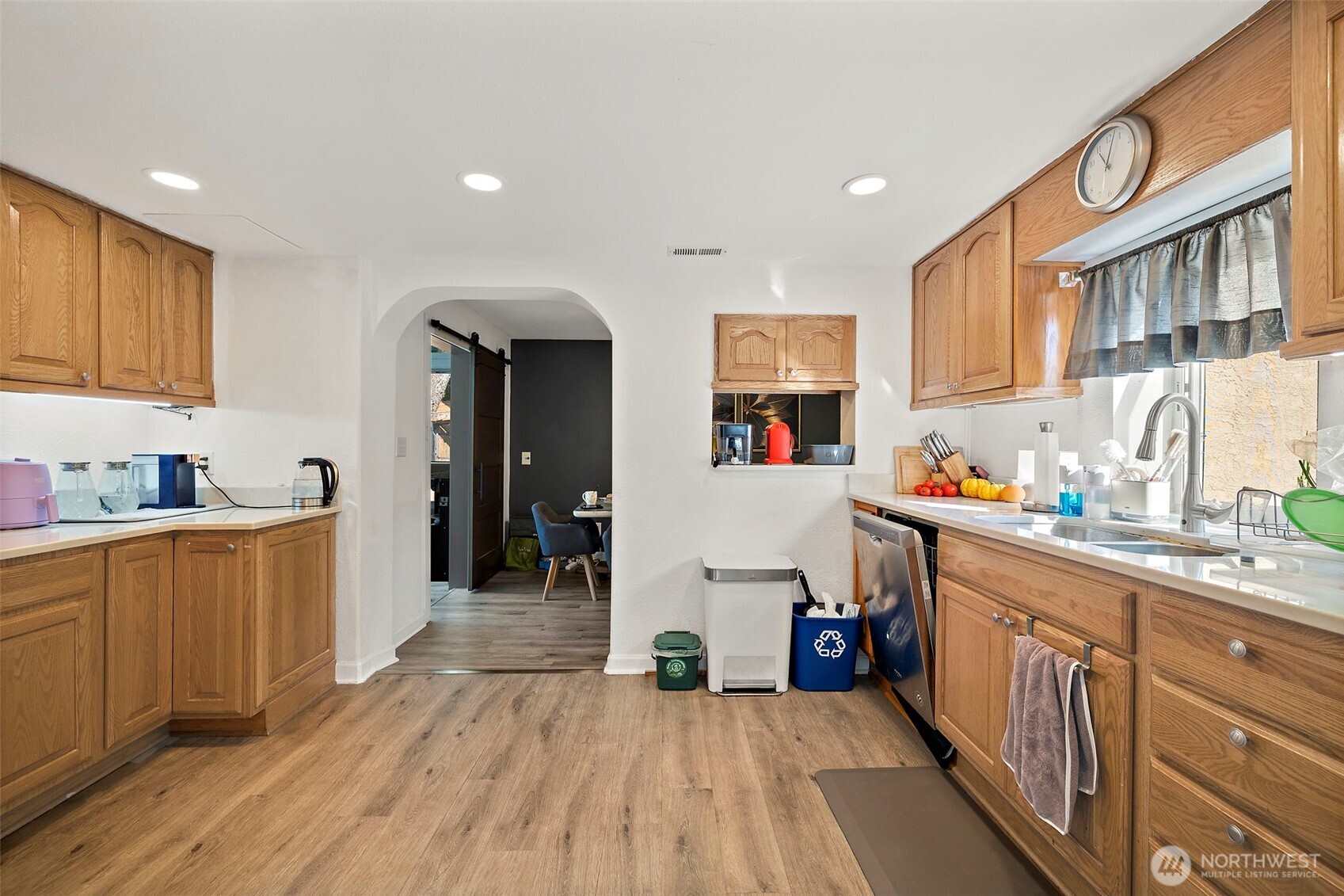 128 Northeast 125th Street Seattle, WA 98125 - Photo 11 of 39 a kitchen with a sink and wooden floor