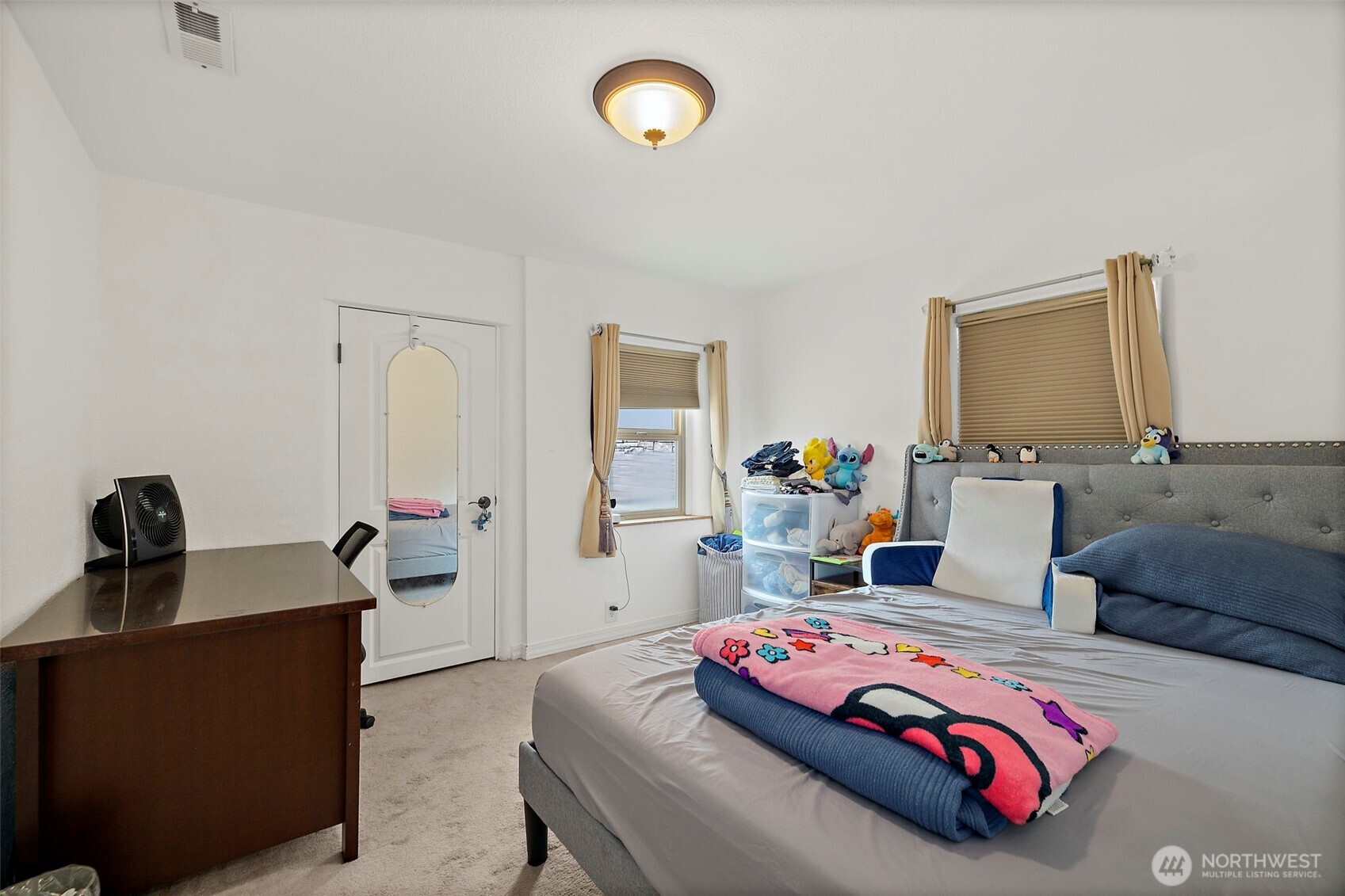 128 Northeast 125th Street Seattle, WA 98125 - Photo 18 of 39 a bedroom with bed and a mirror