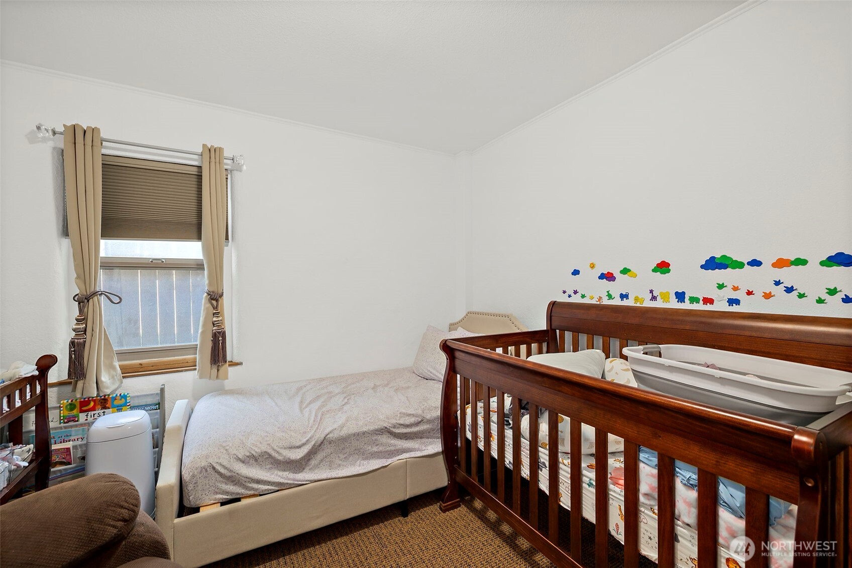 128 Northeast 125th Street Seattle, WA 98125 - Photo 19 of 39 a bedroom with a bed and window