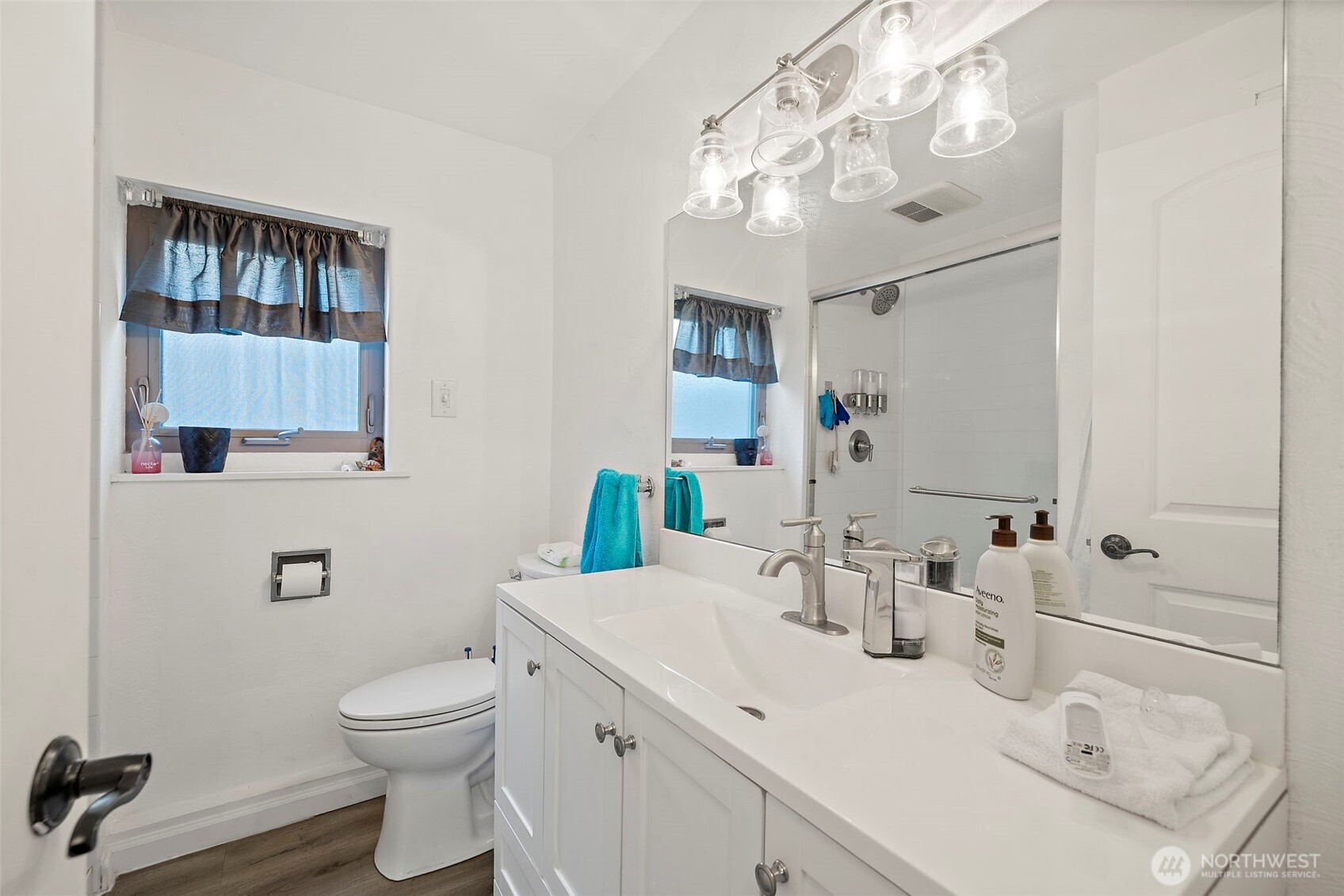 128 Northeast 125th Street Seattle, WA 98125 - Photo 20 of 39 a bathroom with a sink toilet and mirror