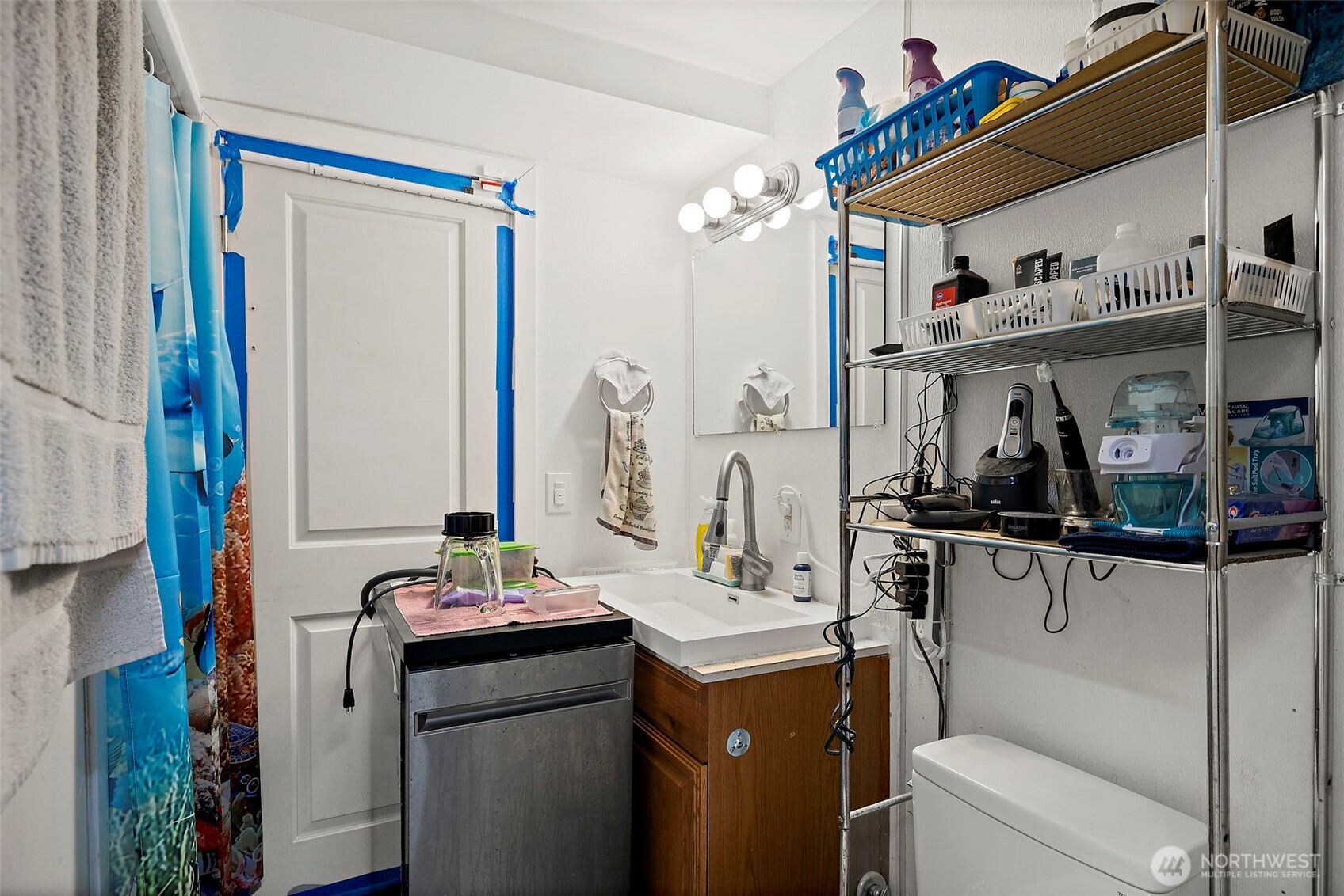 128 Northeast 125th Street Seattle, WA 98125 - Photo 30 of 39 a bathroom with a sink and a mirror