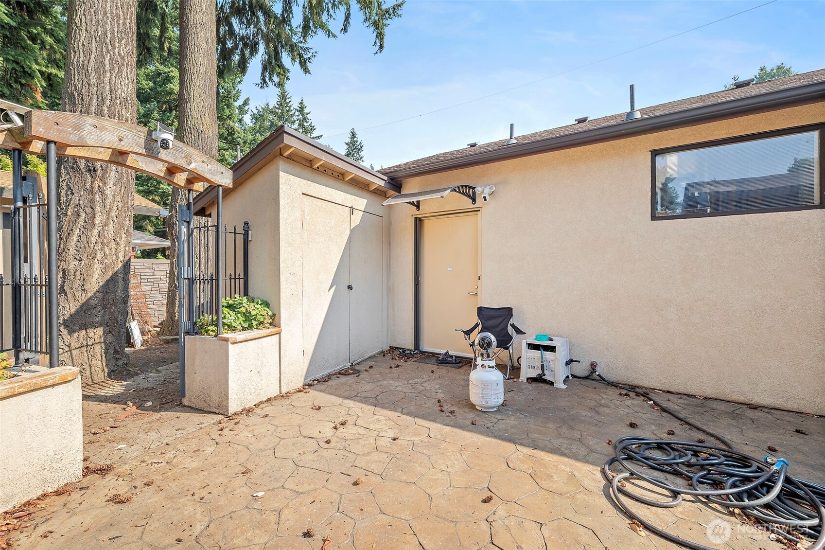 128 Northeast 125th Street Seattle, WA 98125 - Photo 32 of 39 a backyard of a house with wooden fence and a potted plant