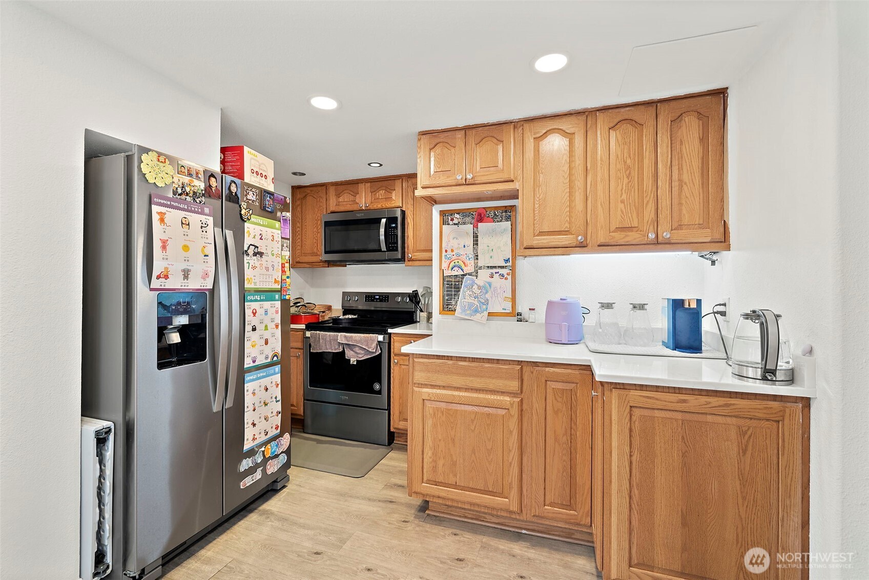 128 Northeast 125th Street Seattle, WA 98125 - Photo 7 of 39 a kitchen with a refrigerator and a sink