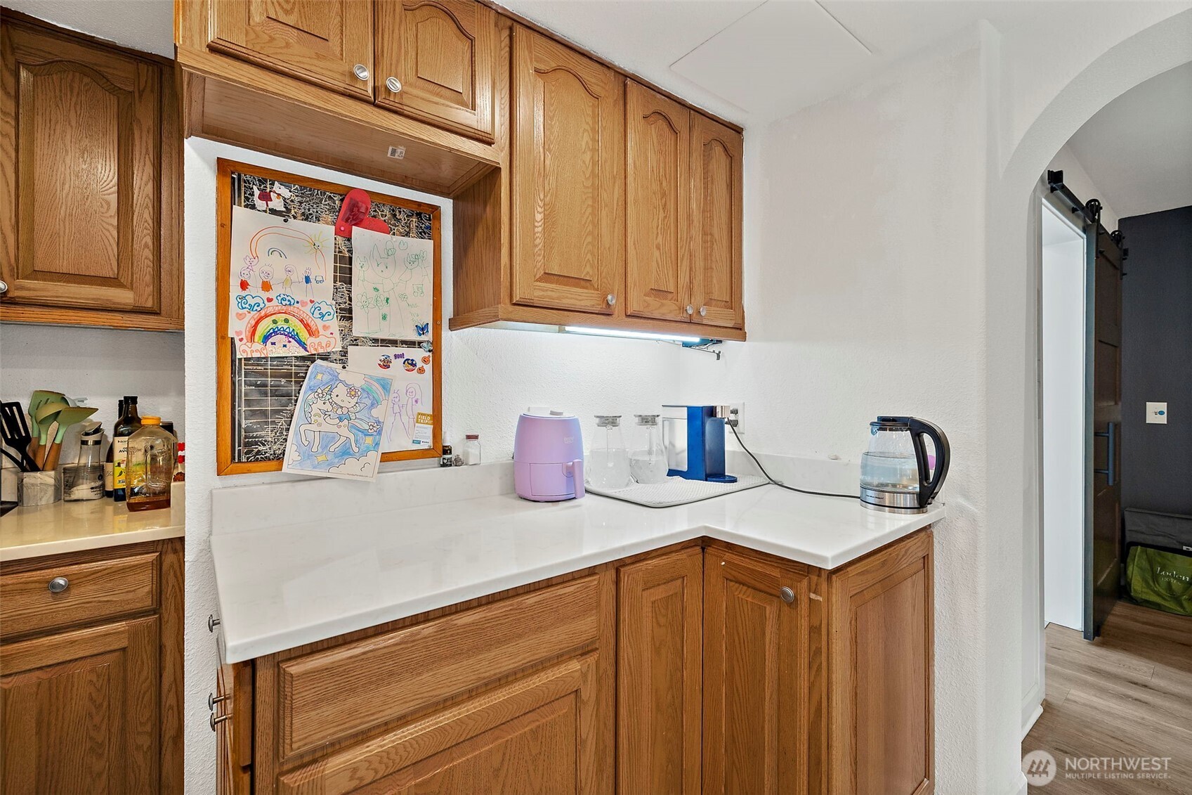 128 Northeast 125th Street Seattle, WA 98125 - Photo 9 of 39 a kitchen with stainless steel appliances granite countertop a sink a stove and cabinets