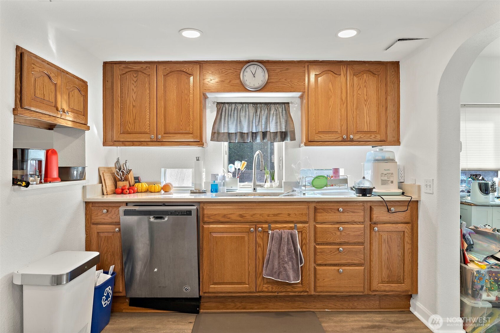 128 Northeast 125th Street Seattle, WA 98125 - Photo 10 of 39 a kitchen with stainless steel appliances granite countertop a sink and cabinets