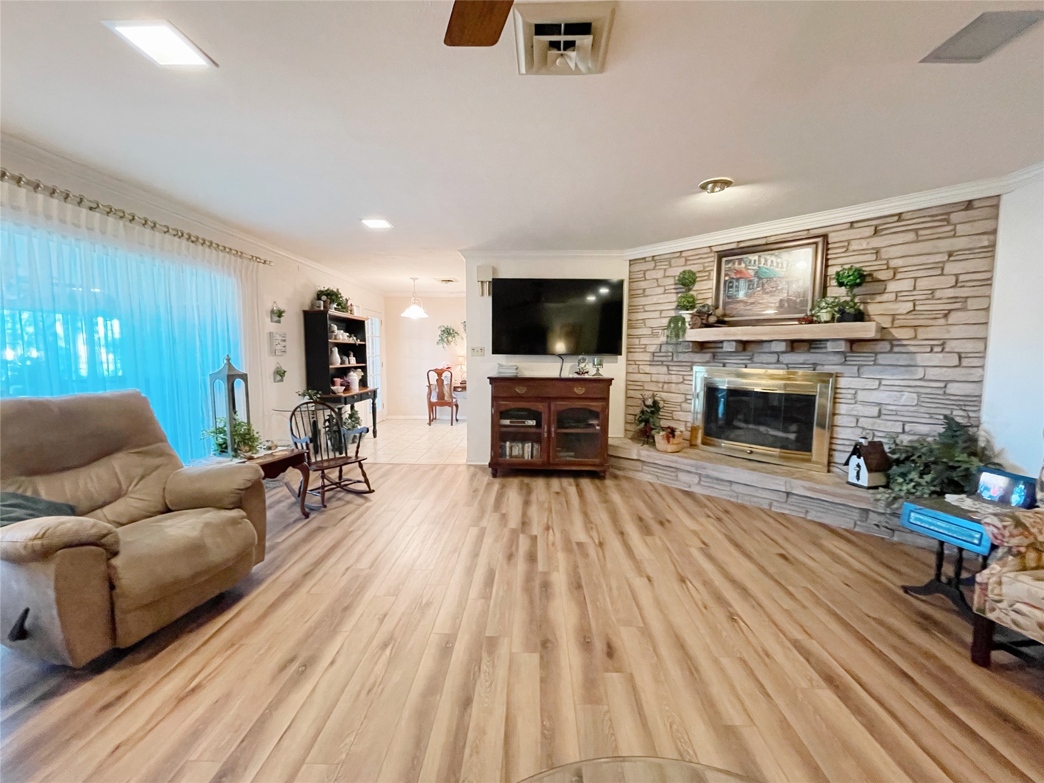 700 Shanklin Road Belton, TX 76513 - Photo 9 of 33 a living room with furniture a flat screen tv and a fireplace