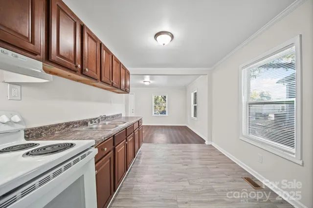 a kitchen with granite countertop a stove and a sink