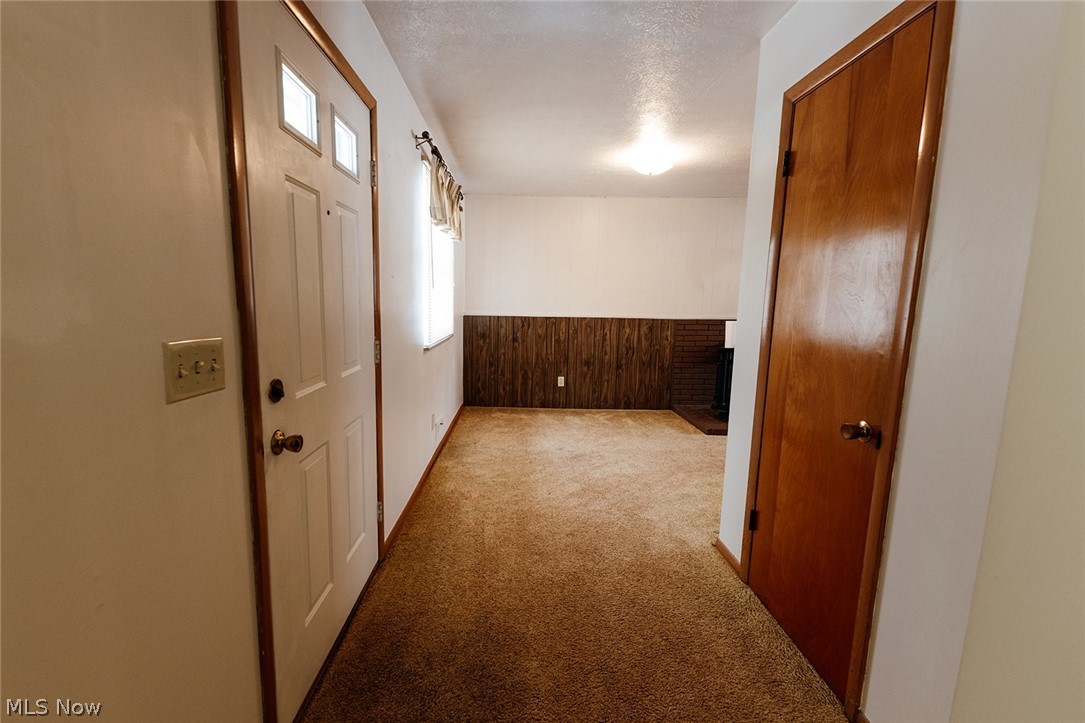 19545 Alexander Road Bedford, OH 44146 - Photo 6 of 29 Hallway featuring a textured ceiling and light carpet