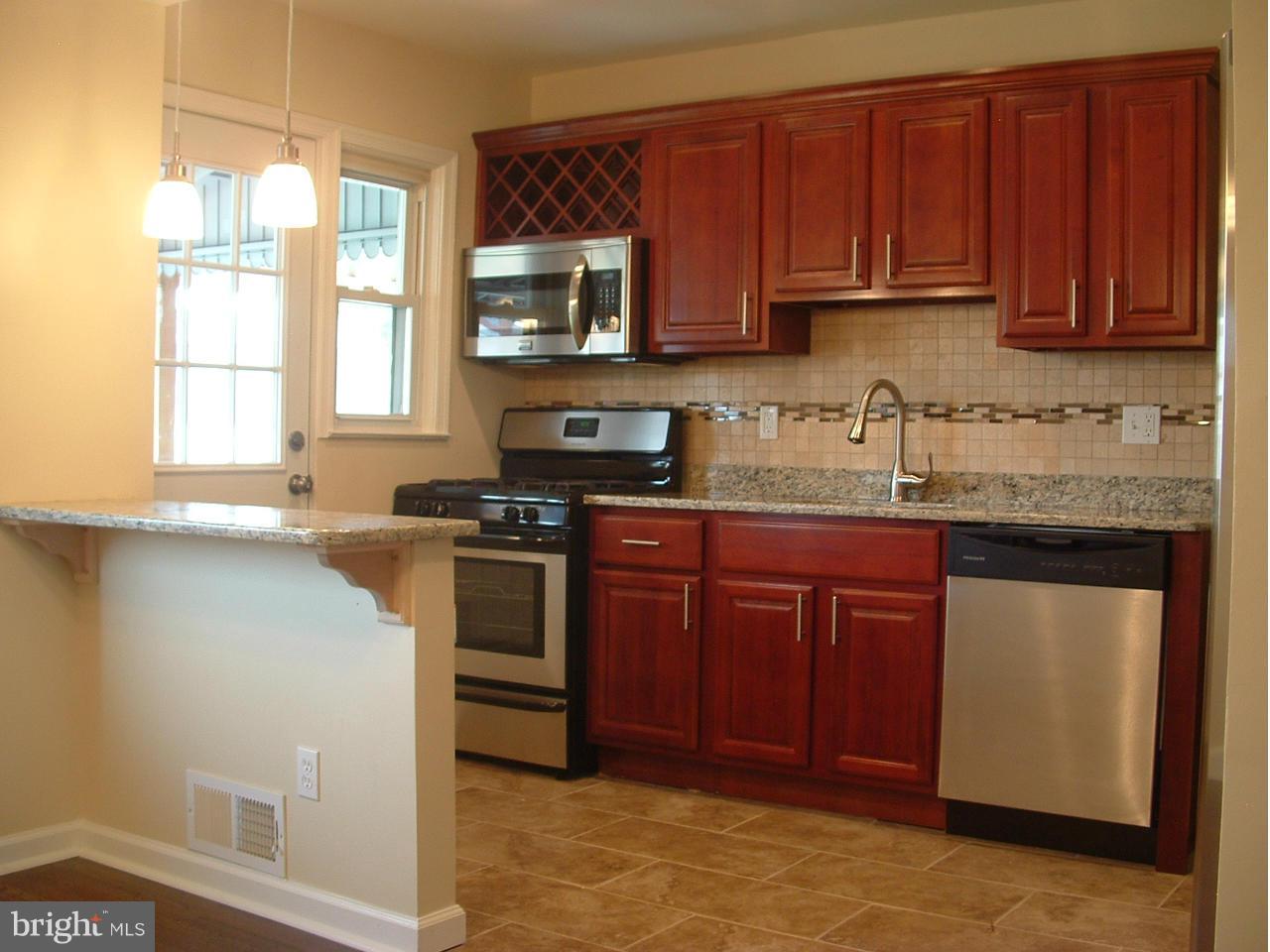 338 Torner Road Baltimore, MD 21221 - Photo 2 of 30 a kitchen with stainless steel appliances granite countertop a sink stove and microwave