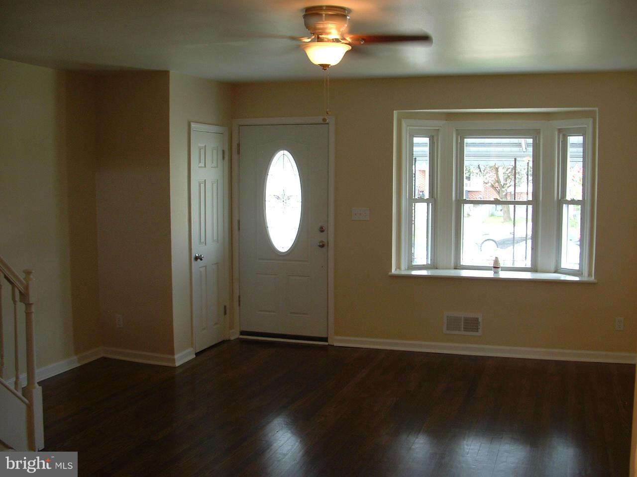 338 Torner Road Baltimore, MD 21221 - Photo 14 of 30 an empty room with wooden floor mirror and windows