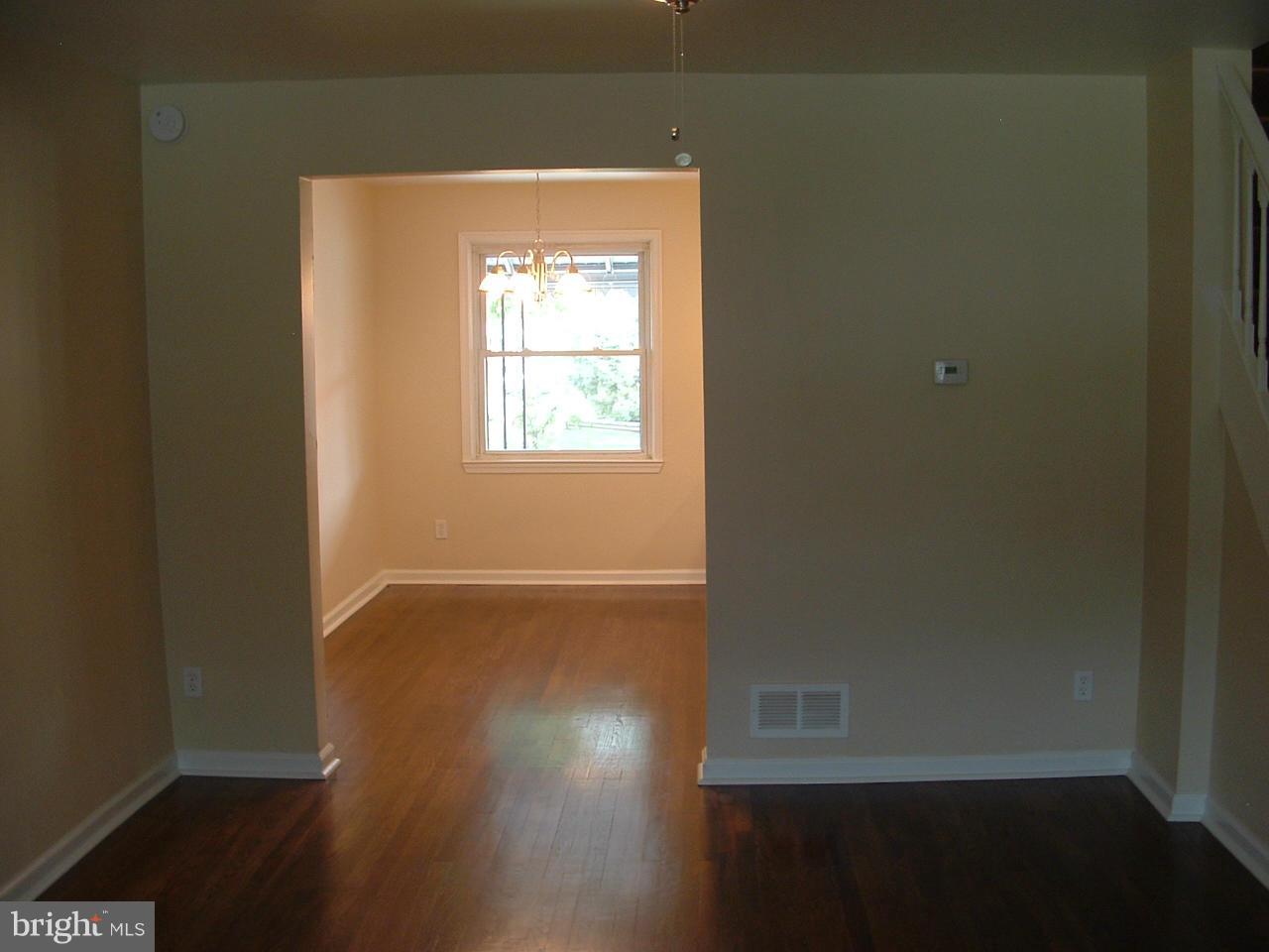338 Torner Road Baltimore, MD 21221 - Photo 16 of 30 an empty room with wooden floor and windows