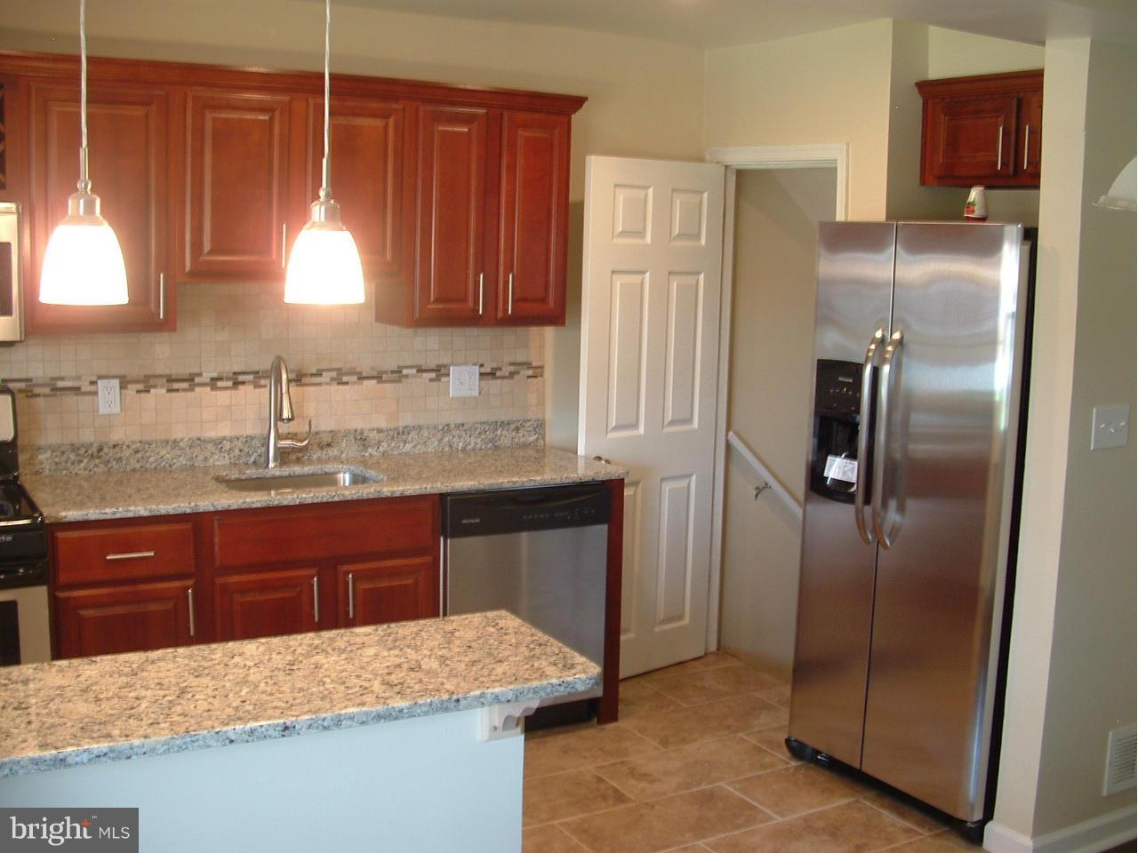 338 Torner Road Baltimore, MD 21221 - Photo 5 of 30 a kitchen with stainless steel appliances granite countertop a refrigerator and a sink