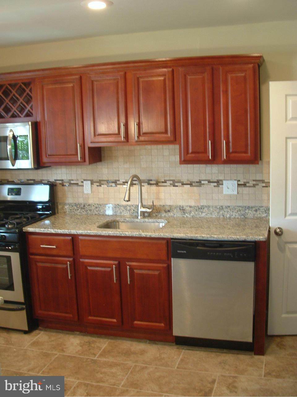 338 Torner Road Baltimore, MD 21221 - Photo 6 of 30 a kitchen with stainless steel appliances granite countertop a stove a sink dishwasher and a granite counter top