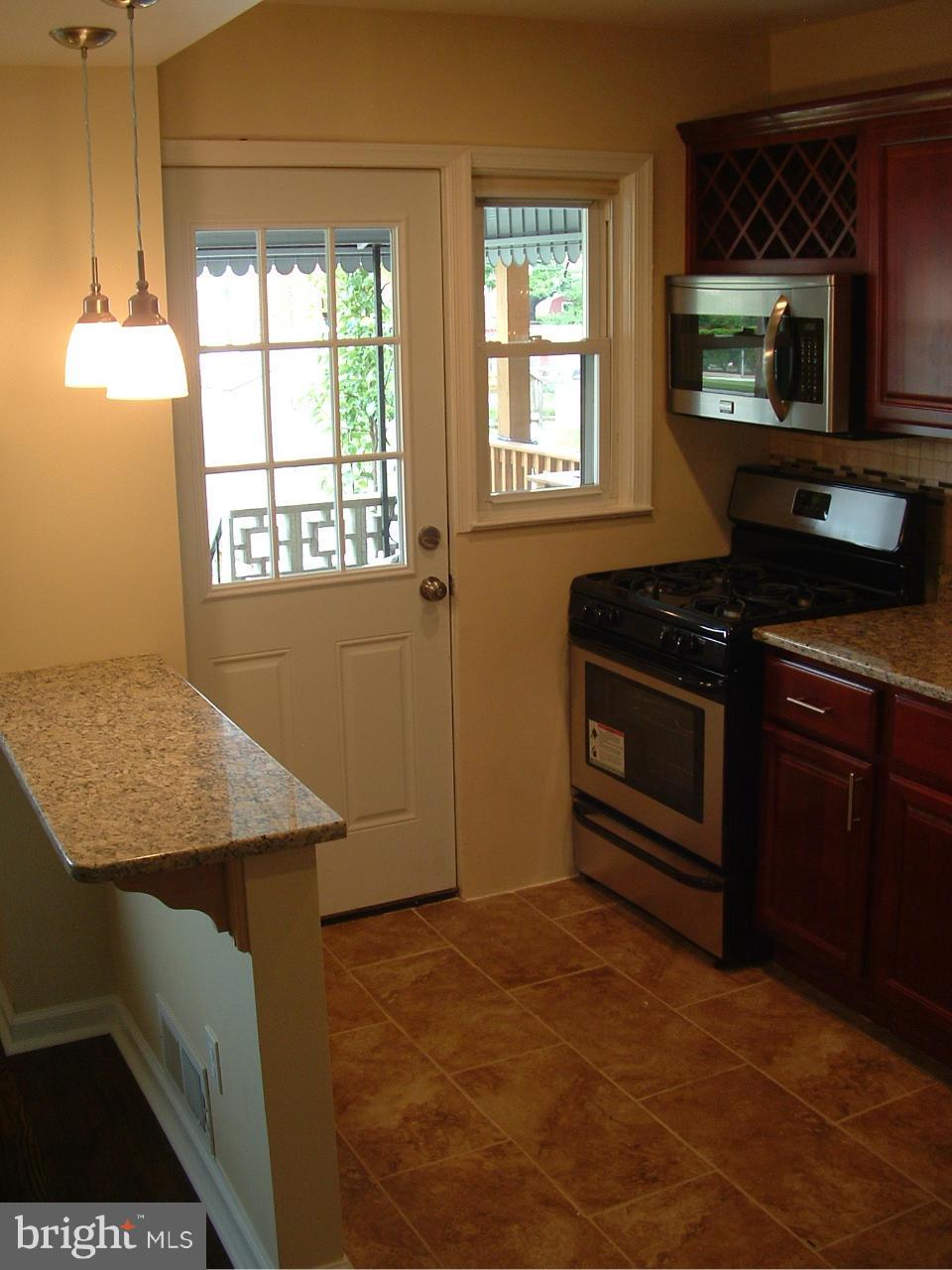 338 Torner Road Baltimore, MD 21221 - Photo 8 of 30 a kitchen with a stove and a microwave