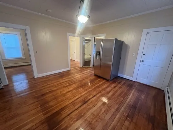 a view of a refrigerator in wooden floor