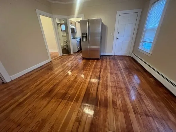 a view of a room with wooden floor and stairs