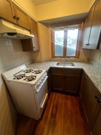 a kitchen that has a sink and a stove