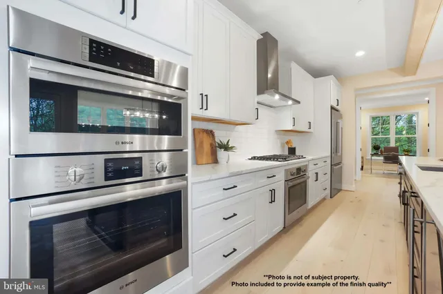 a kitchen with stainless steel appliances a stove microwave and cabinets