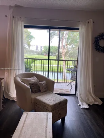 a living room with couch and a floor to ceiling window