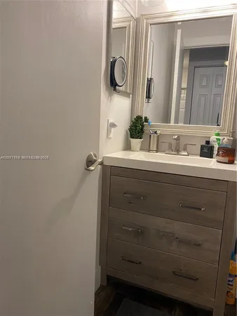 a bathroom with a double vanity sink and mirror