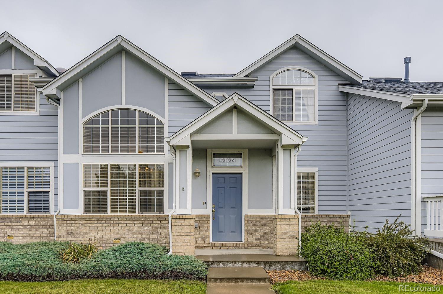 Undisclosed Address Aurora, CO 80013 - Photo 1 of 20 a front view of a house with a yard and garage
