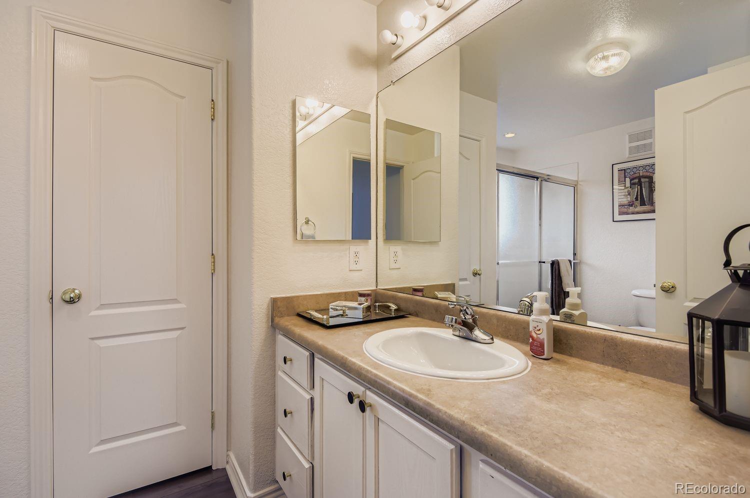 Undisclosed Address Aurora, CO 80013 - Photo 13 of 20 a bathroom with a sink and a mirror