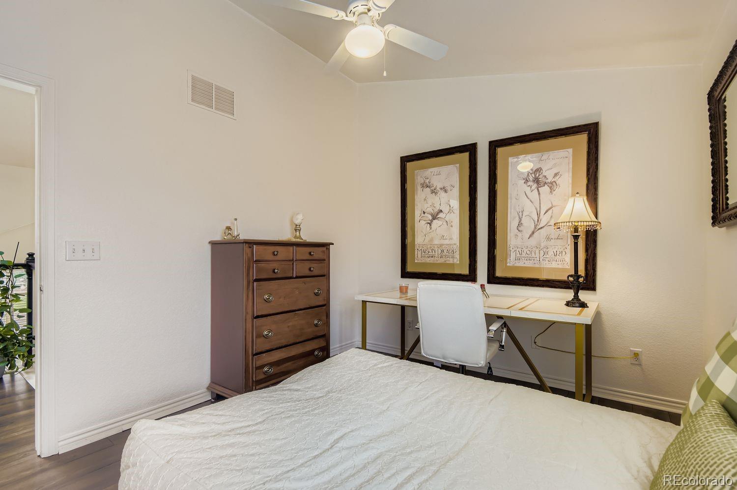 Undisclosed Address Aurora, CO 80013 - Photo 16 of 20 a bedroom with a bed and a dresser