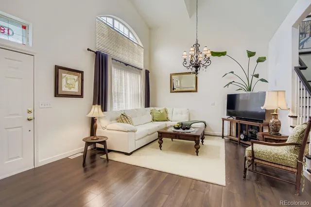 a living room with furniture a rug and a flat screen tv