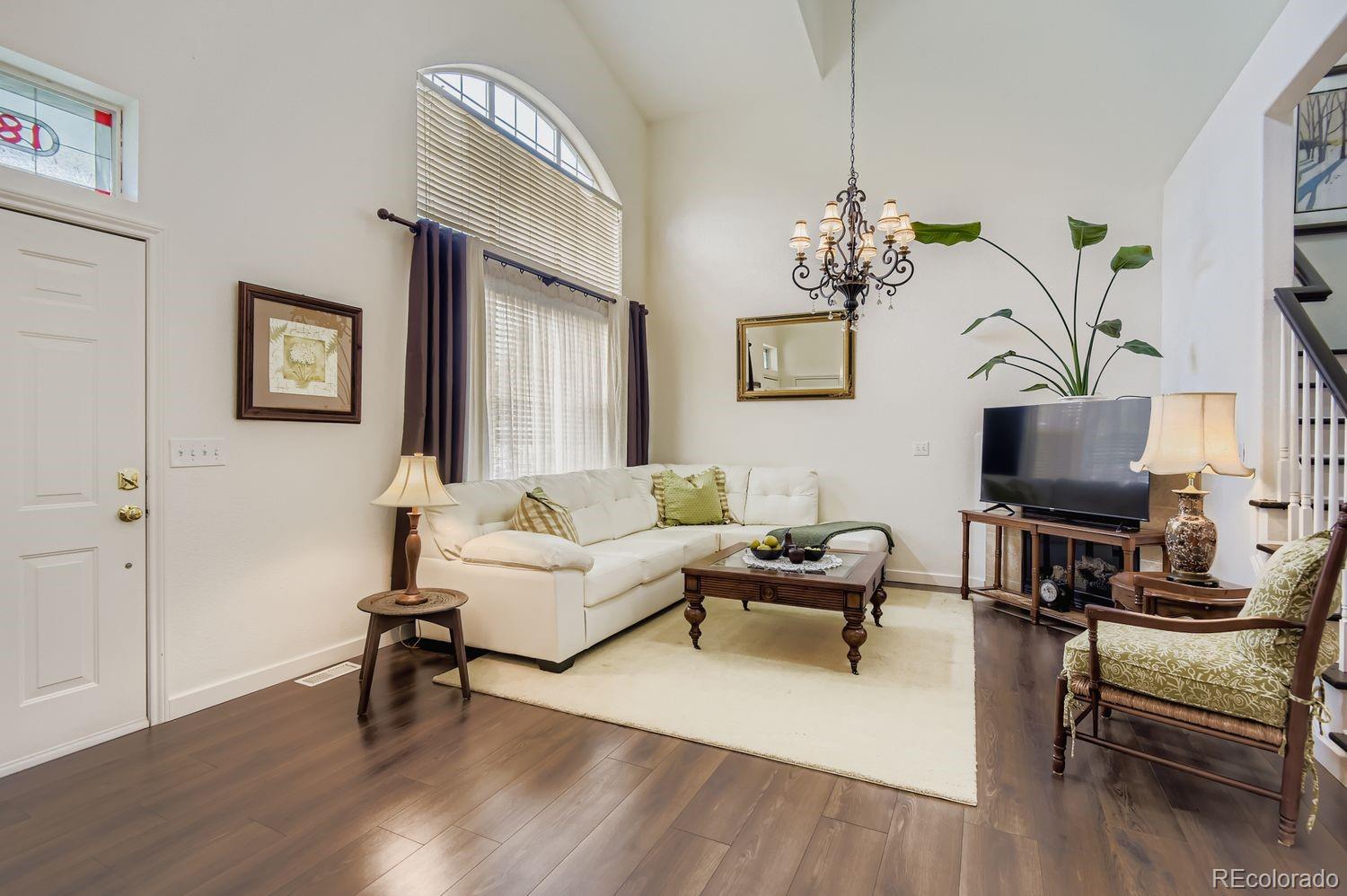 Undisclosed Address Aurora, CO 80013 - Photo 3 of 20 a living room with furniture a rug and a flat screen tv