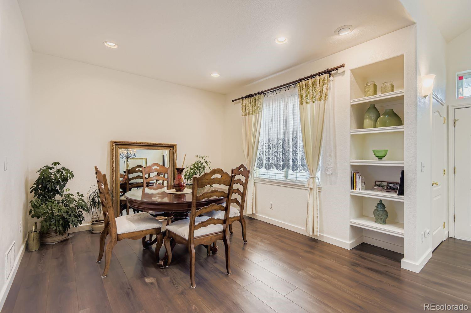Undisclosed Address Aurora, CO 80013 - Photo 4 of 20 a view of a dining room with furniture and wooden floor