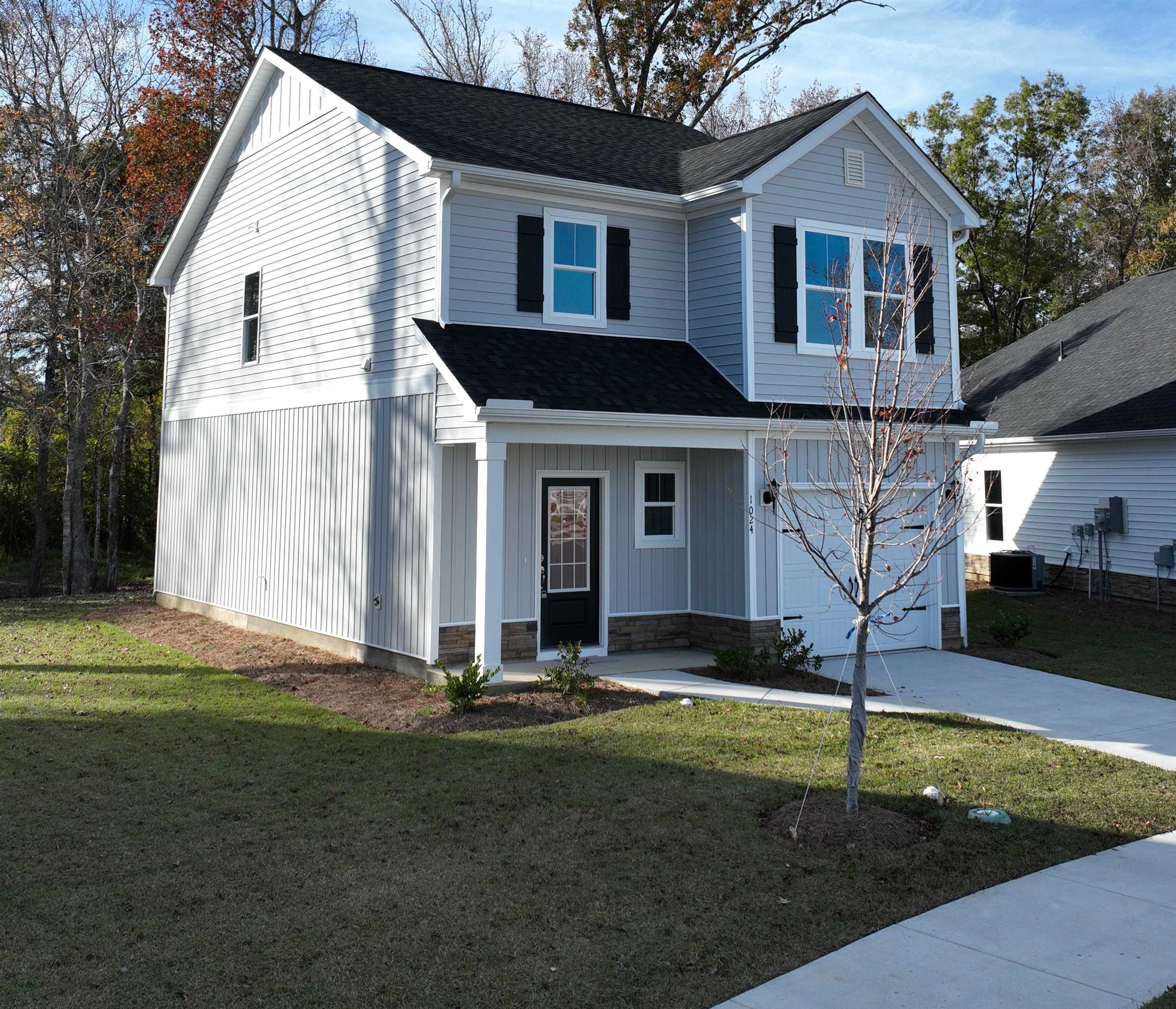 1032 Moen Loop, Unit LOT 9 Conway, SC 29526 - Photo 2 of 36 View of front of home featuring covered porch, a front yard, an attached garage, and a shingled roof