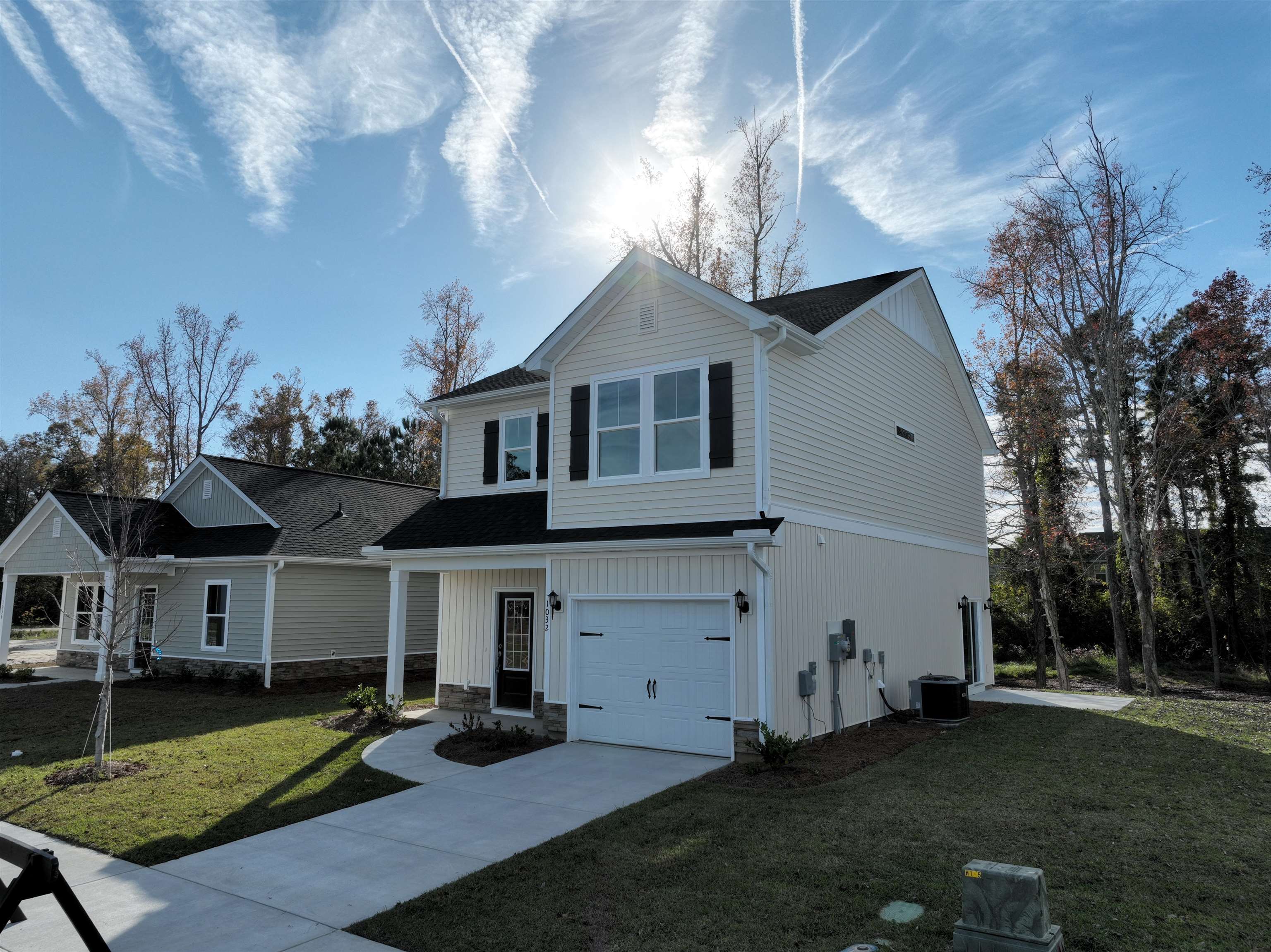 1032 Moen Loop, Unit LOT 9 Conway, SC 29526 - Photo 3 of 36 Traditional-style house with a front yard, driveway, a shingled roof, and a garage