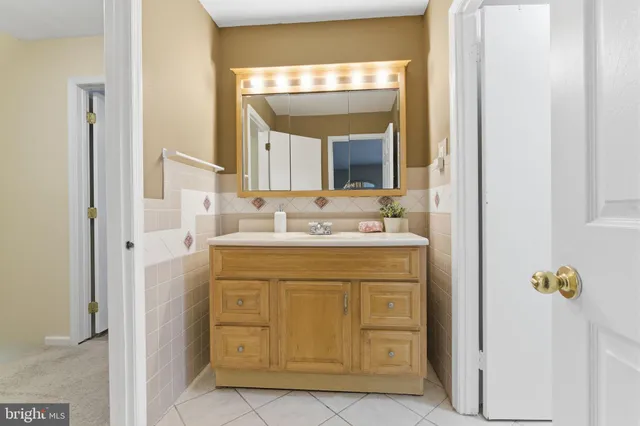 a bathroom with a sink vanity and a mirror