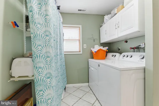 a utility room with a window and washer