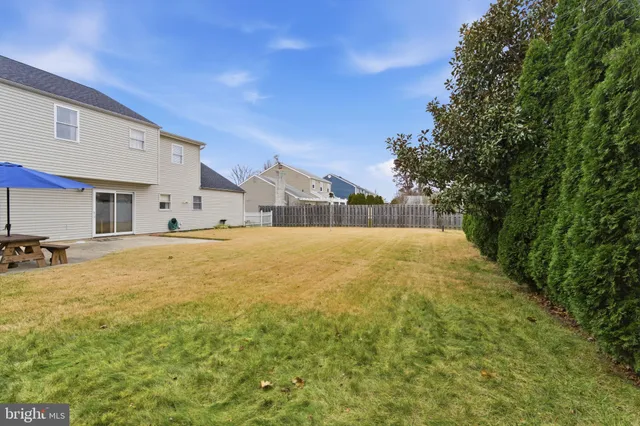 a swimming pool with outdoor seating and yard