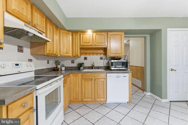 a kitchen with a stove a sink and a refrigerator