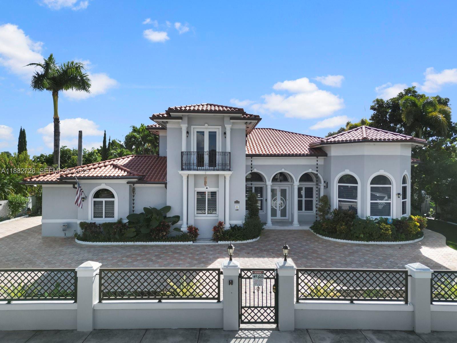 12770 Southwest 188th Street Miami, FL 33177 - Photo 1 of 65 a front view of a house with a yard and garage