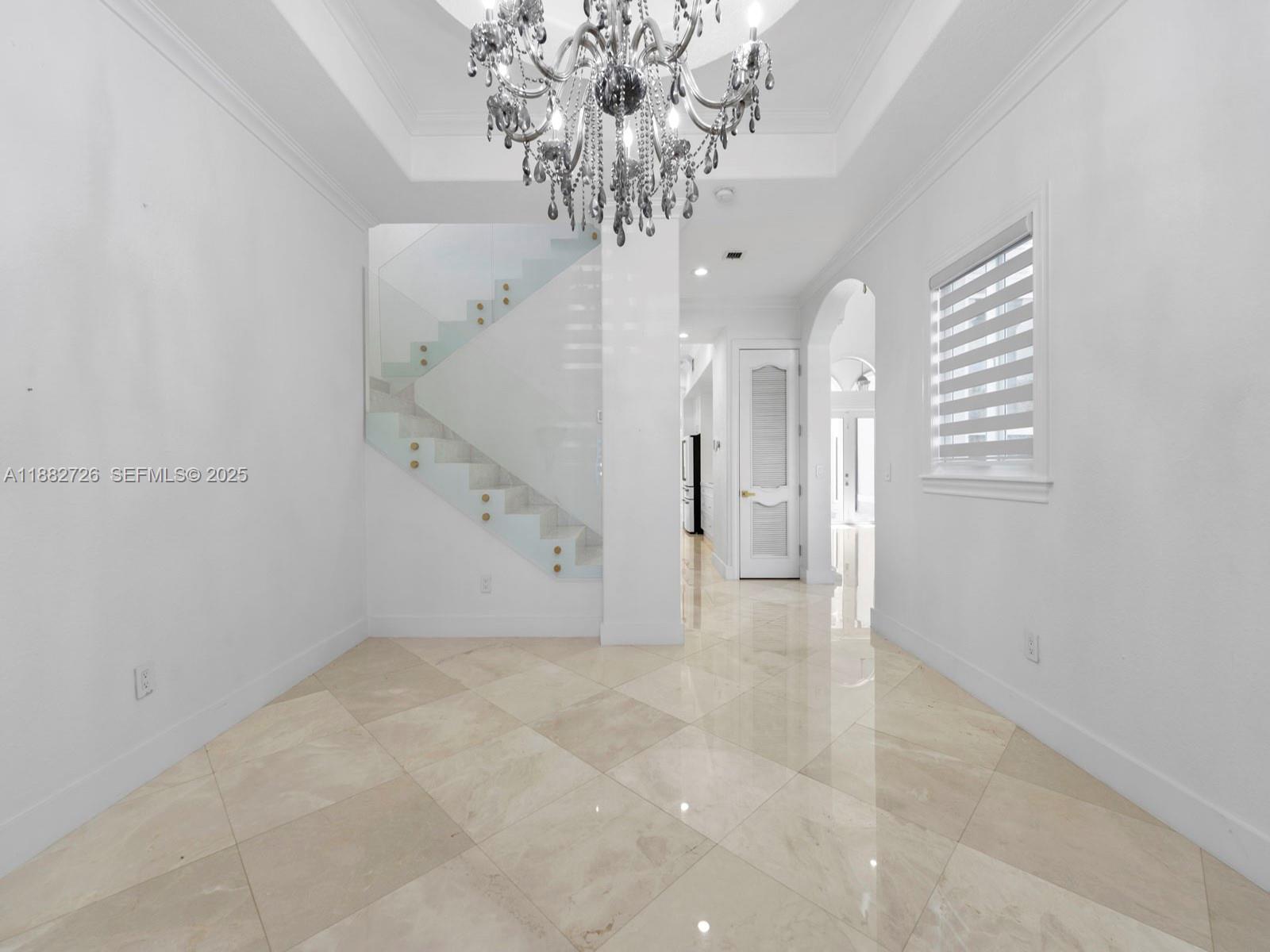 12770 Southwest 188th Street Miami, FL 33177 - Photo 14 of 65 a view of a big room with a chandelier fan and windows