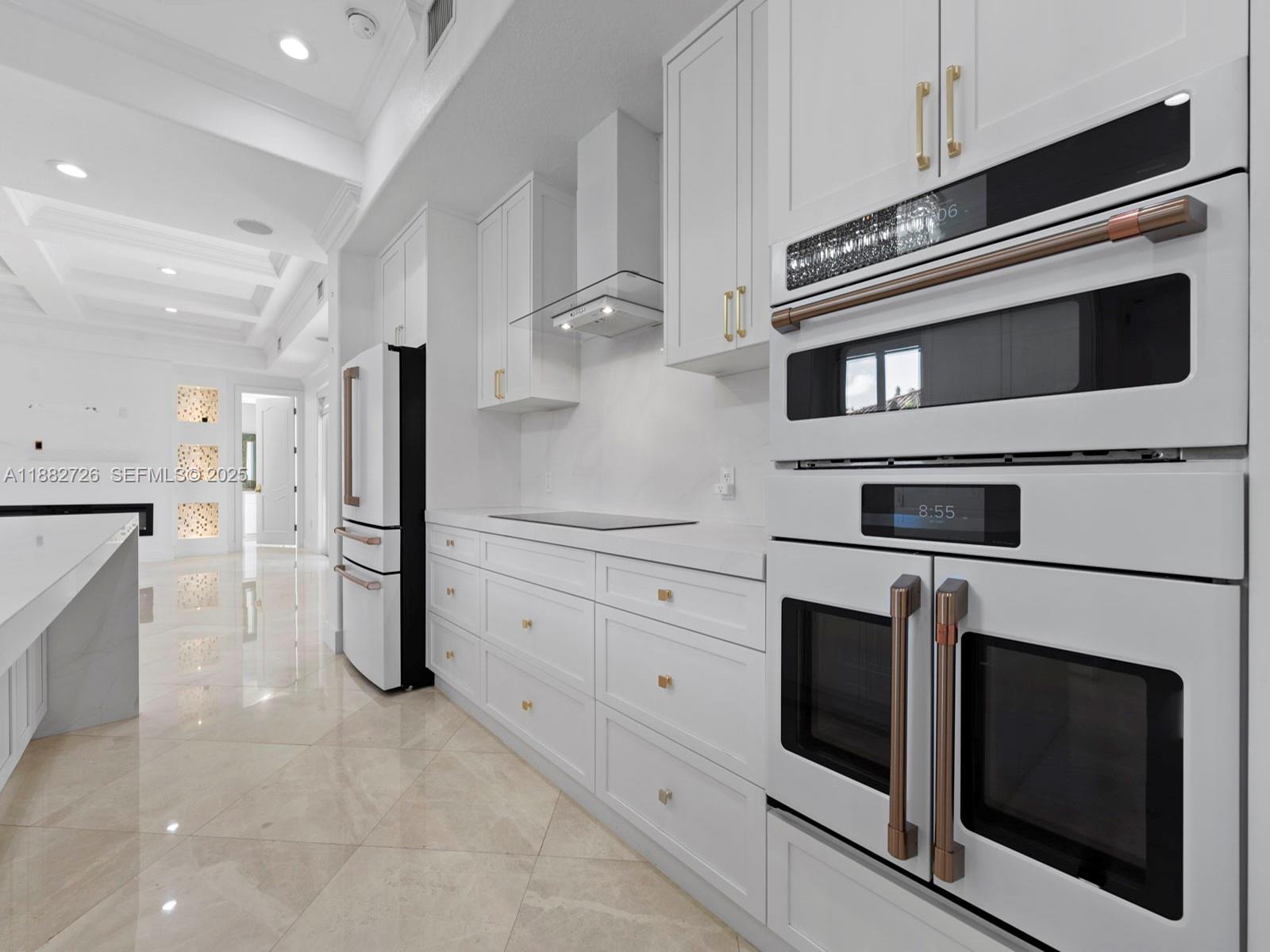 12770 Southwest 188th Street Miami, FL 33177 - Photo 17 of 65 a kitchen with stainless steel appliances white cabinets and a fireplace