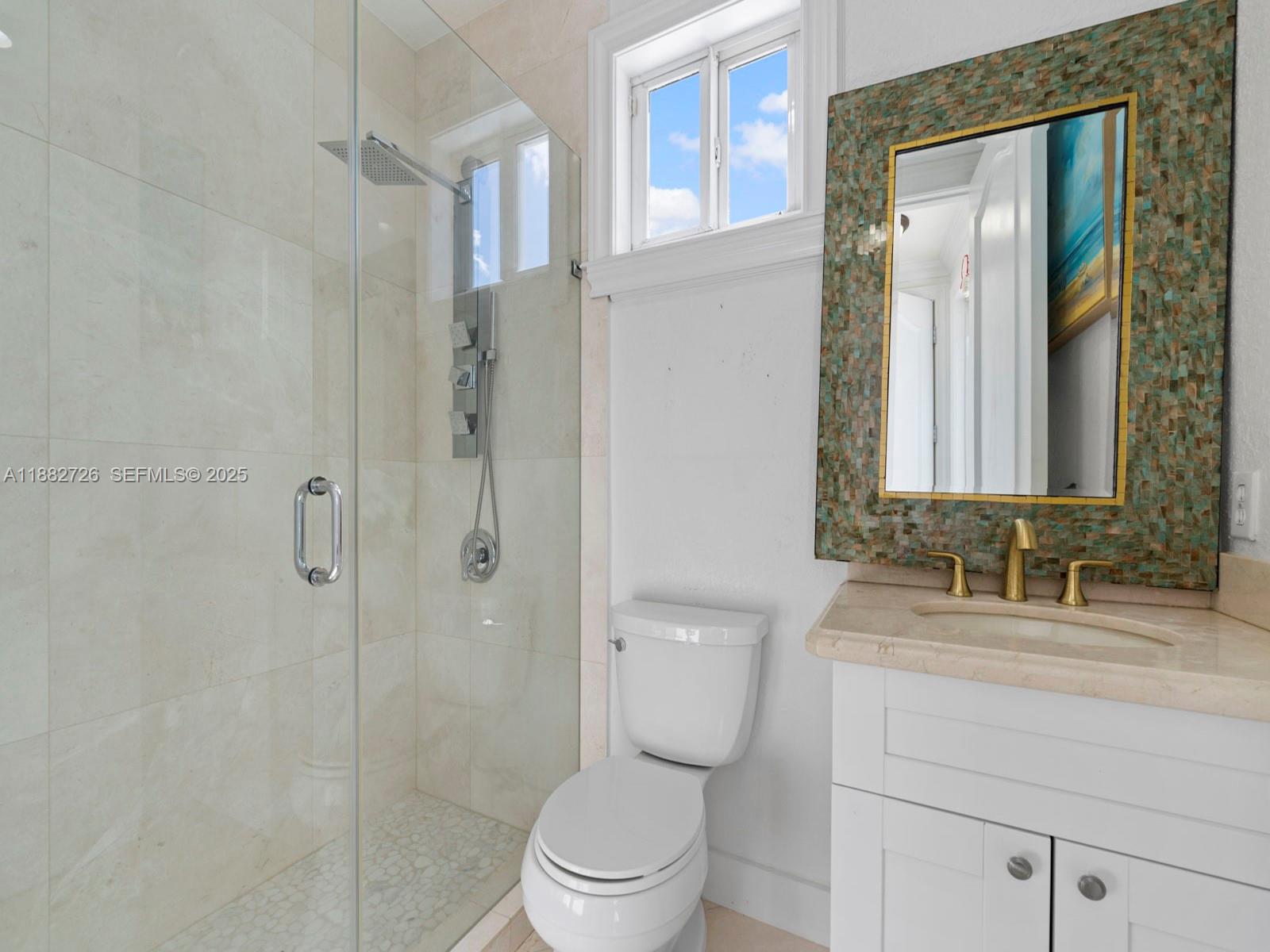 12770 Southwest 188th Street Miami, FL 33177 - Photo 23 of 65 a bathroom with a toilet a sink and shower