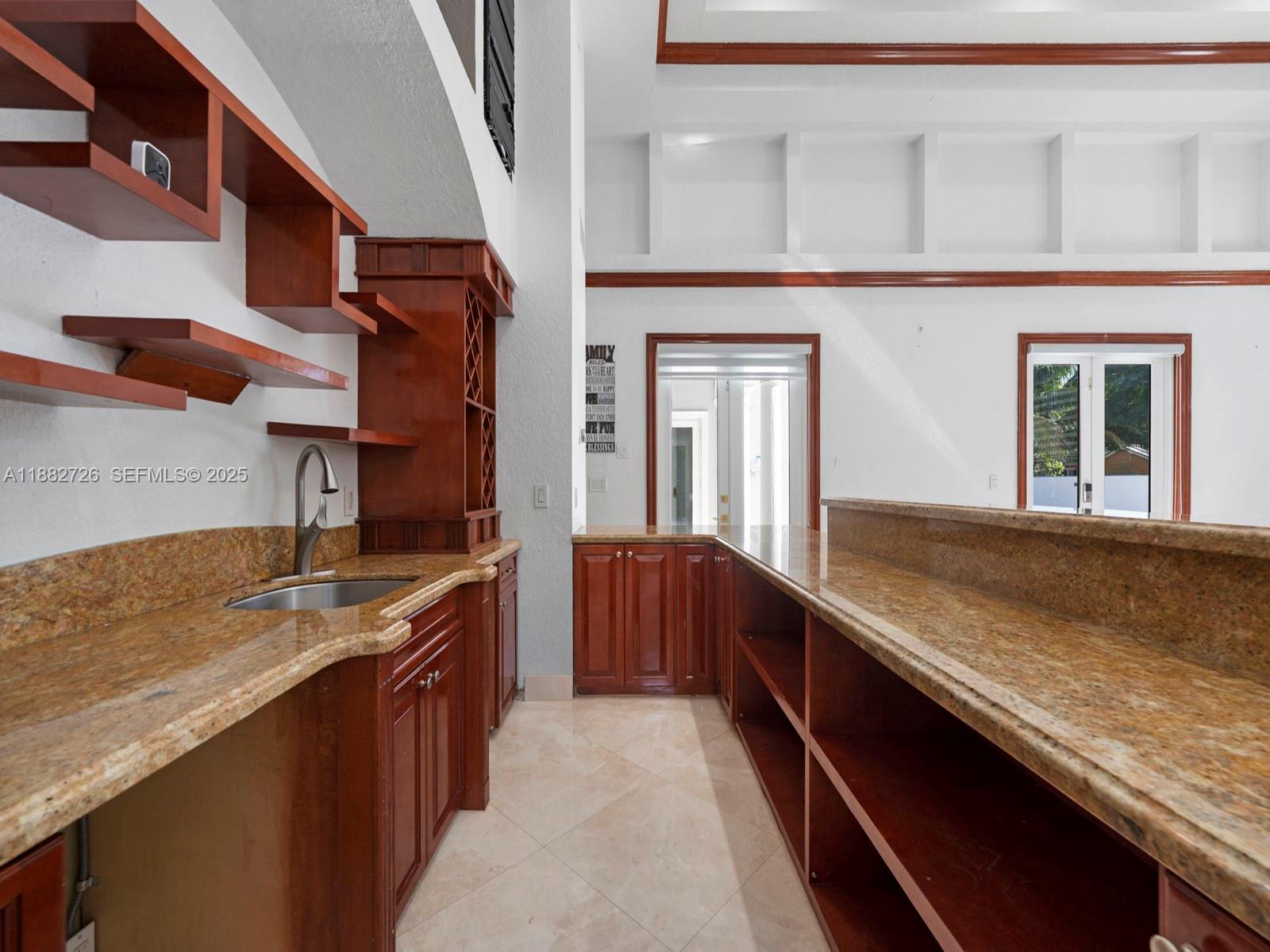 12770 Southwest 188th Street Miami, FL 33177 - Photo 29 of 65 a kitchen with granite countertop sink stove and cabinets