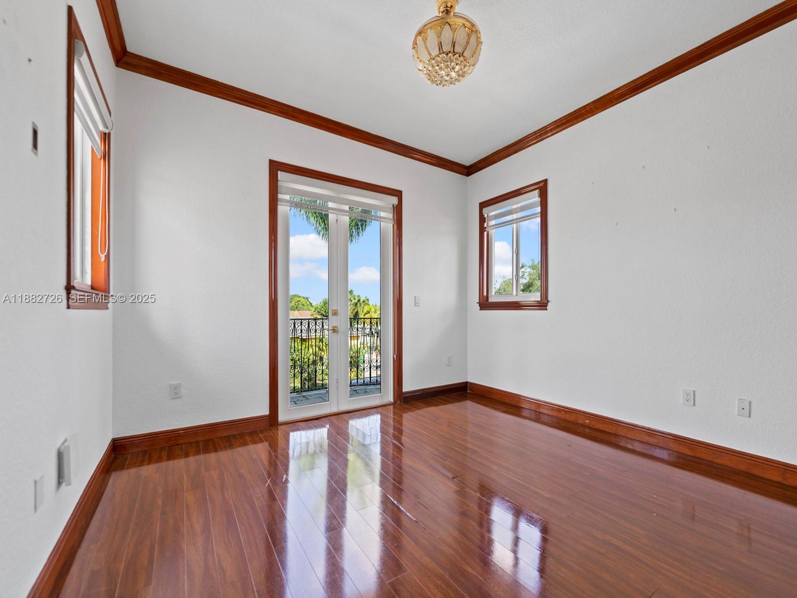 12770 Southwest 188th Street Miami, FL 33177 - Photo 33 of 65 a view of an empty room with window and wooden floor