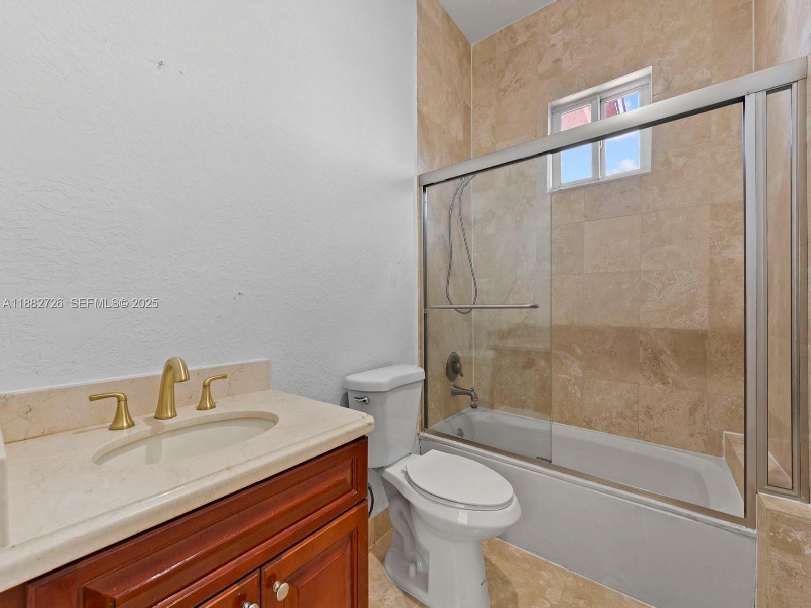 12770 Southwest 188th Street Miami, FL 33177 - Photo 35 of 65 a bathroom with a sink a toilet and shower