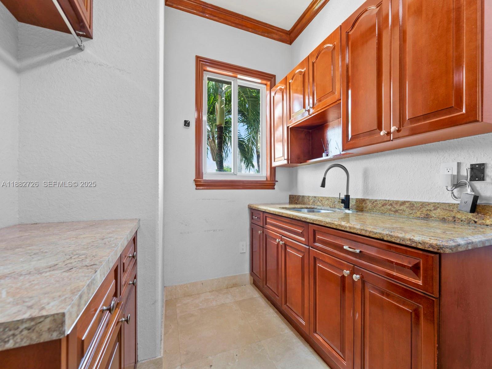 12770 Southwest 188th Street Miami, FL 33177 - Photo 39 of 65 a kitchen with stainless steel appliances granite countertop a sink and a wooden cabinets