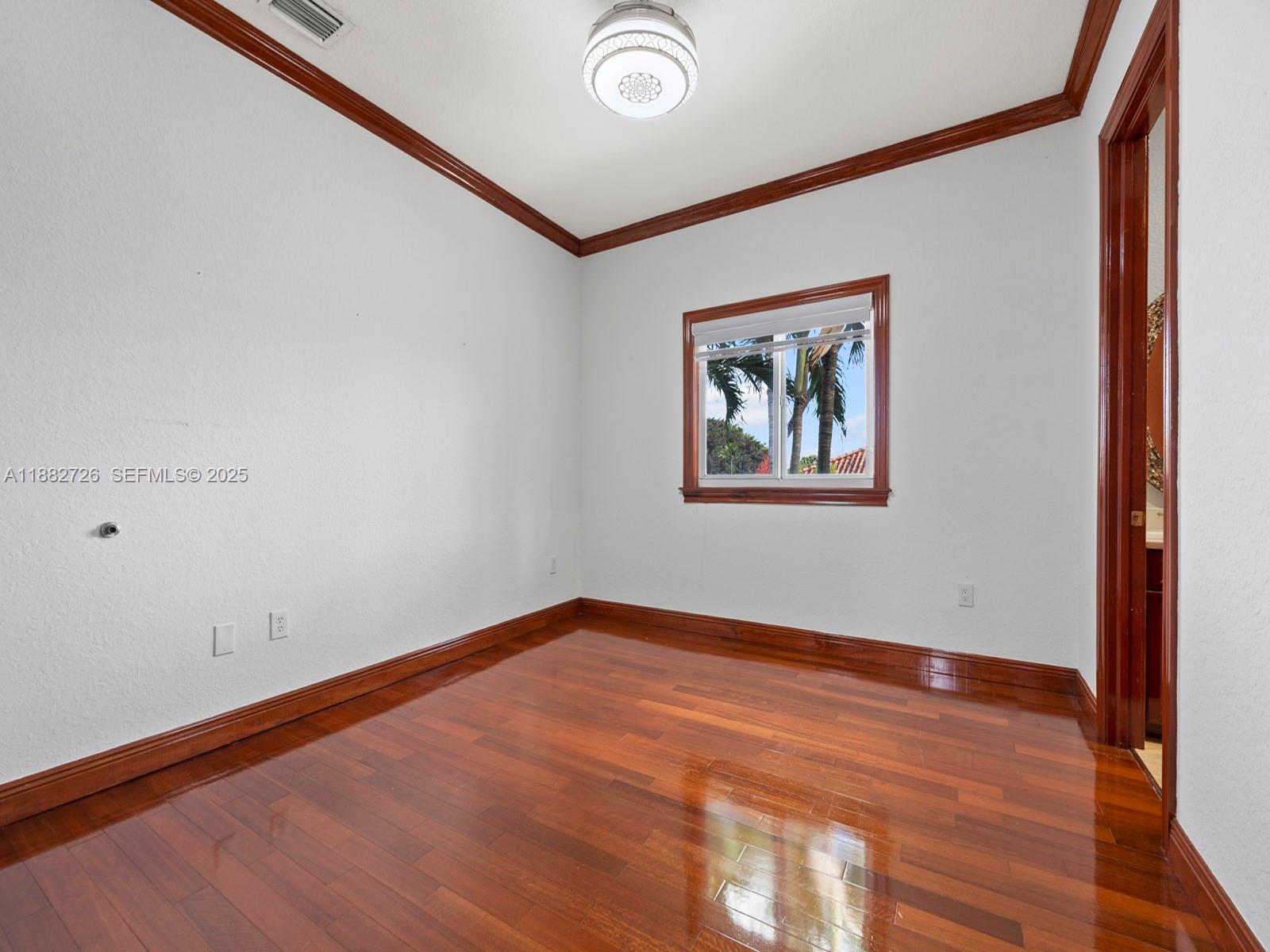 12770 Southwest 188th Street Miami, FL 33177 - Photo 40 of 65 an empty room with wooden floor and windows