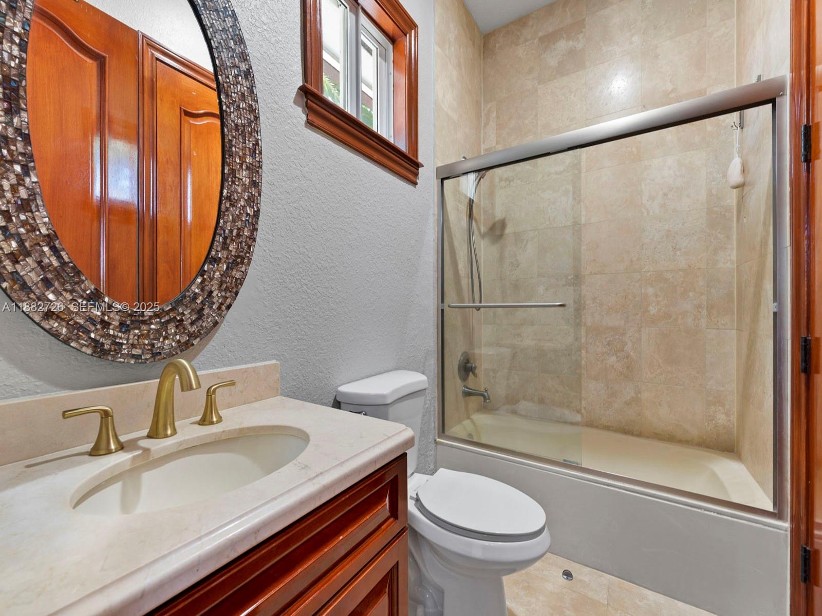 12770 Southwest 188th Street Miami, FL 33177 - Photo 42 of 65 a bathroom with a sink and a mirror