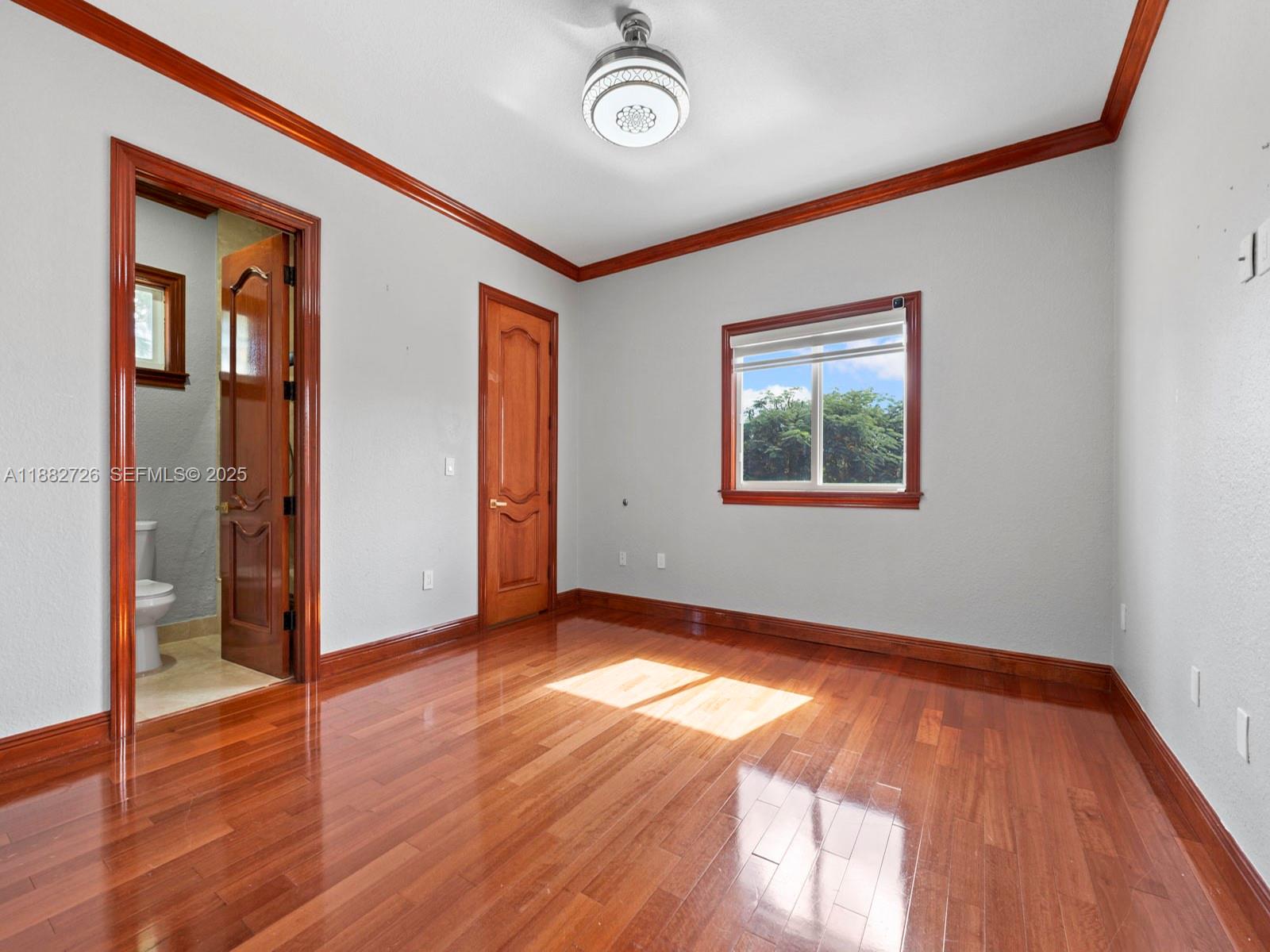 12770 Southwest 188th Street Miami, FL 33177 - Photo 43 of 65 a view of an empty room with wooden floor and a window