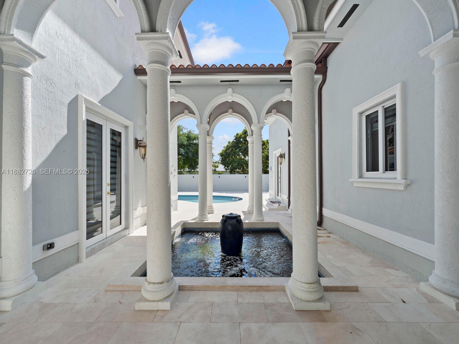 12770 Southwest 188th Street Miami, FL 33177 - Photo 44 of 65 a view of a livingroom with a floor to ceiling window and a fireplace