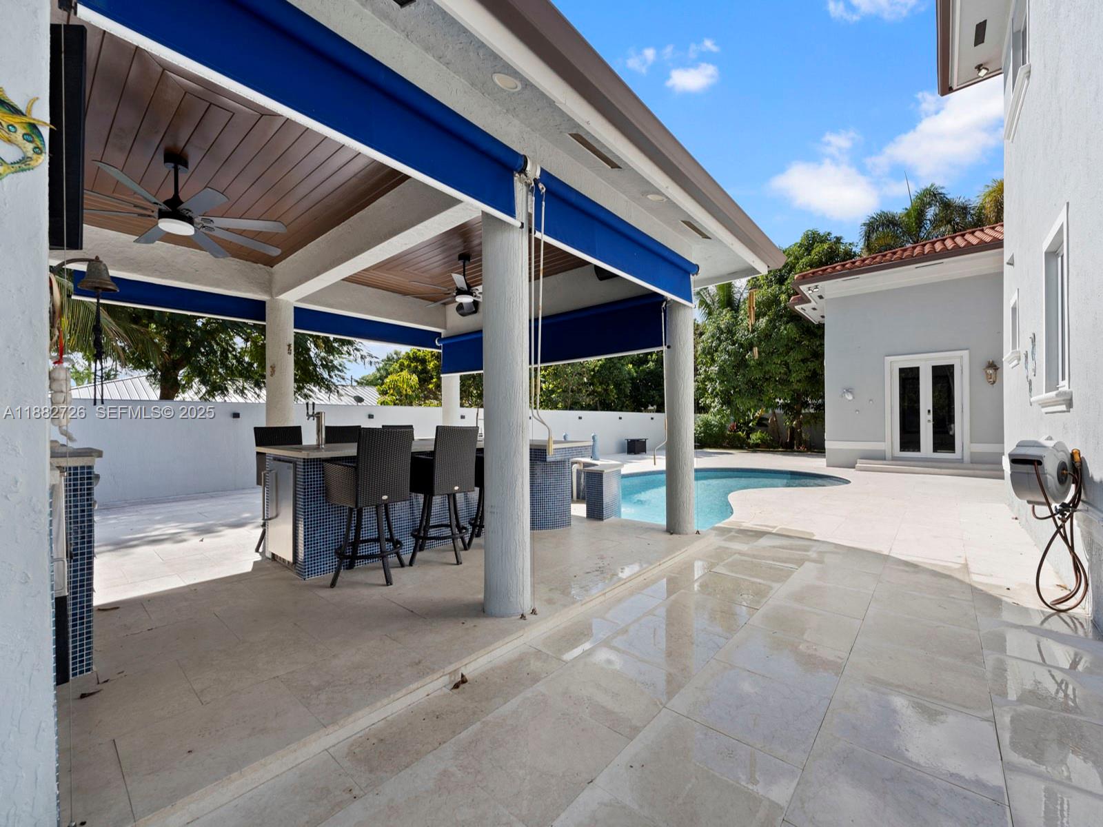 12770 Southwest 188th Street Miami, FL 33177 - Photo 55 of 65 a view of a patio with a table and chairs and potted plants