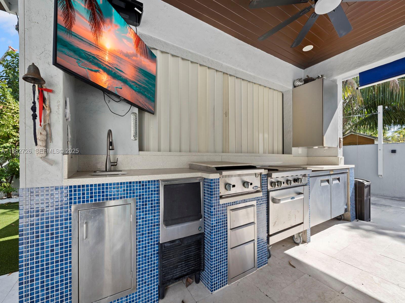 12770 Southwest 188th Street Miami, FL 33177 - Photo 56 of 65 a kitchen with stainless steel appliances granite countertop a stove a sink and a microwave